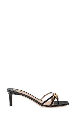 A black TOM FORD Whitney Mule 1 with a small heel, featuring a gold embellishment on the straps. the shoe is displayed against a plain white background.