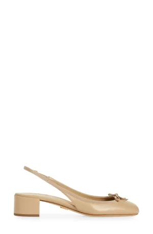 A PRADA Triangle Logo Bow Slingback Pump 1 with a pointed toe and a decorative bow, set against a plain white background. the shoe features a low, square heel and a thin strap.