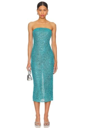 A woman models the NBD Aine Midi Dress 1, a teal, strapless, sequined midi dress, paired with silver heels and a small metallic handbag, standing against a plain background.