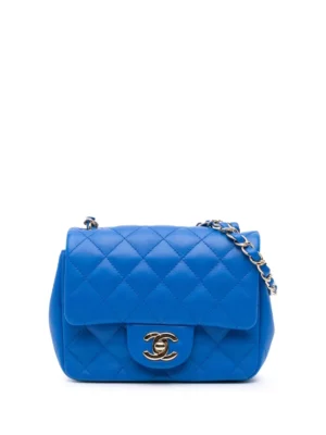 A blue Chanel Pre-Owned Mini Square Classic Lambskin Single Flap Crossbody Bag with quilted leather, a gold chain strap, and a gold clasp featuring an interlocking double C logo on the front flap.