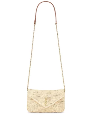 A rectangular woven straw handbag inspired by the Saint Laurent Cassandre Raffia Clutch, featuring a flap closure, gold-tone chain shoulder strap with a brown leather section, natural beige color, and a textured pattern.