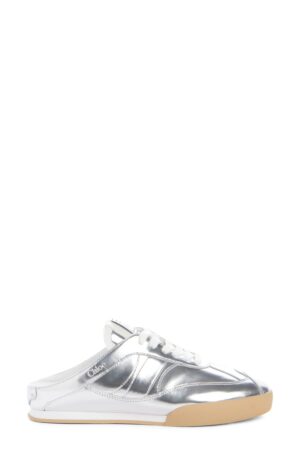 A silver metallic slip-on sneaker with white laces, white sole detail, and a tan rubber outsole, the Chloe Kick Sneaker features the brand name "Chloé" near the heel and an open back, giving it a stylish mule-inspired look.