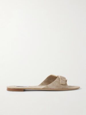 The Briar Suede Slides feature a light beige suede upper, open toe, and a single wide strap with a small matching buckle, all displayed against a plain white background.