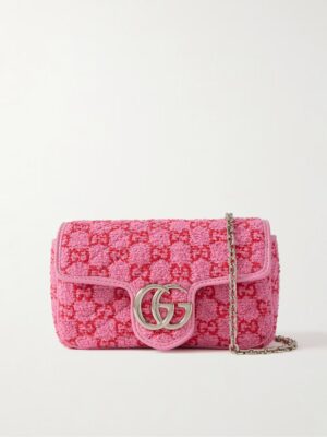 A rectangular pink Gucci Blondie Small Leather Shoulder Bag with a silver chain strap, pink trim, and a prominent silver double G logo on the front flap. The bag features textured fabric with a repeating pink and red pattern.