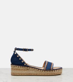 A single Valentino Garavani Rockstud Espadrille Wedge Sandal with an ankle strap, metallic stud accents, and a thick woven jute sole, displayed on a white surface against a plain light background.