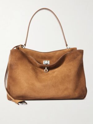 A large, brown Balenciaga Rodeo Medium Suede Shoulder Bag with a single strap, silver clasp closure, and minimal design is photographed against a plain white background.