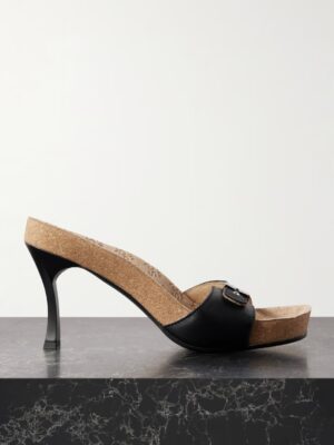 A black open-toe heeled sandal with a cork platform and sole, inspired by Balenciaga 55mm Buckle-Fastening Square-Toe Sandals, featuring a thin high heel and black strap with metallic buckle, displayed on a dark marble surface.
