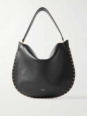 A black leather hobo bag inspired by the Isabel Marant Oskan Leather-Trimmed Tassled Studded Suede Shoulder Bag, featuring a single strap, gold-tone stud details along the sides, and a small gold logo at the bottom center on a plain white background.