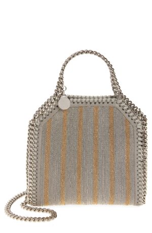 A structured Stella McCartney Falabella Mini Raffia Tote Bag with silver chain handles and trim, featuring vertical gold and silver stripes. A round silver charm hangs from one handle and a matching chain strap is attached.