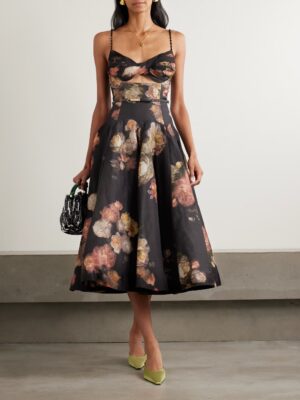 A person wearing a Zimmermann Hypnotic Picnic Belted Lace-Trimmed Linen and Silk-Blend Midi Dress with thin straps, holding a small black-and-white handbag and wearing yellow pointed heels, stands against a plain light background.