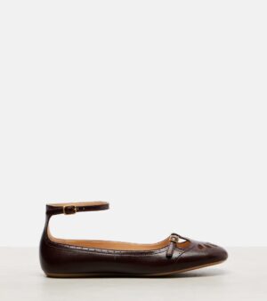 A single dark brown leather flat shoe, reminiscent of the Chloé Mae Paddington Sandal, features a rounded toe, small buckle strap across the front, and an ankle strap with a buckle, displayed against a plain light background.