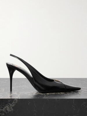 Black pointed-toe slingback pump with a stiletto heel and gold hardware detail on the upper, reminiscent of Saint Laurent Chandelle Satin Sandals, displayed on a black marble surface against a plain light background.