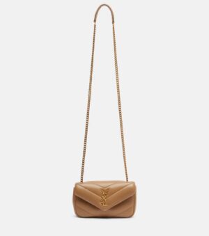 A tan Saint Laurent Loulou Quilted Leather Shoulder Bag with a gold chain strap and gold YSL logo on the front flap, displayed against a white background.