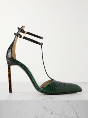 A single Tom Ford Snake-effect Leather Pump with a pointed toe, dark green snakeskin texture, two black ankle straps with buckles, and a high stiletto heel, displayed on a white marble surface.