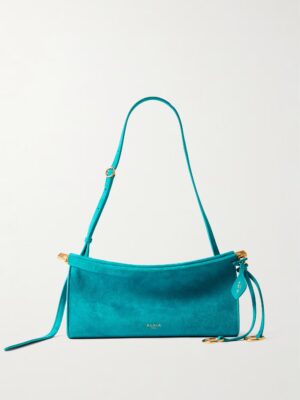 A turquoise Alaïa Le Click Small Suede Shoulder Bag featuring a curved top, adjustable strap, gold-tone hardware, and a matching leather tag. The brand name “ALAÏA” is embossed in gold near the bottom center.
