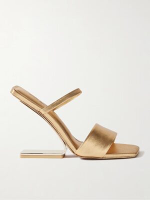 The Cult Gaia Rene Metallic Leather Sandals feature a gold high heel, open toe, a thin instep strap, a wider toe strap, and a uniquely angled, rectangular heel, all beautifully photographed against a plain white background.