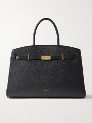 A structured black DeMellier The Hudson Textured-leather Tote with two handles, gold-tone hardware, and a subtle brand logo near the base, set against a plain white background.
