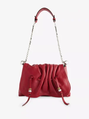 A red leather Isabel Marant Bolton Pouch Shoulder Bag with a gathered, ruched front, silver chain strap, metallic ball accents, and two drawstring-like ties hanging from the front.