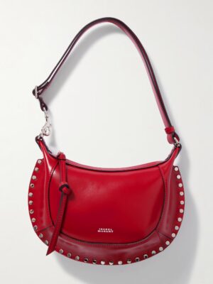 A red leather Isabel Marant Oskan Moon Studded Leather Shoulder Bag featuring silver stud detailing, an adjustable strap, a decorative side knot, and โSTELLA MCCARTNEYโ printed in small white letters on the front.