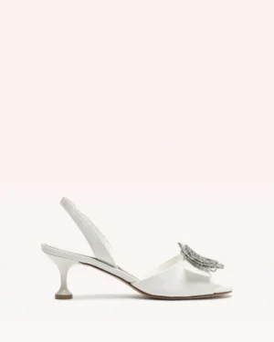 A white open-toe slingback heel with a low, flared heel and an embellished bow detail on the front, the Alexandre Birman Jada 85 Pump is photographed against a light pink background.