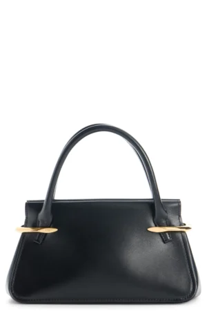 A black Givenchy Pinch Medium Leather Tote Bag with a structured trapezoid shape, two curved handles, and gold oval hardware accents at the base of each handle, set against a white background.