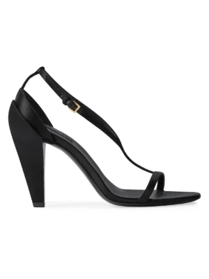 A black Givenchy Block Heeled Sandal with an angular block heel, thin front toe strap, and adjustable ankle strap with a small gold buckle. This shoe features a minimalist and modern design.