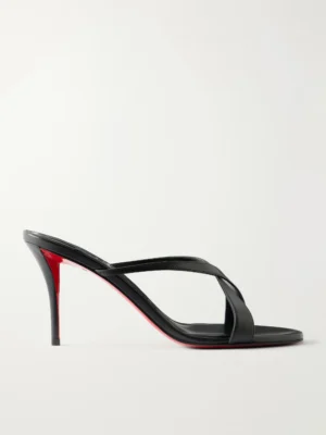A black high-heeled sandal inspired by the Christian Louboutin Mulazee Cross Metallic Leather Mules, featuring thin crisscross straps and a signature red sole, shown in profile against a plain white background.
