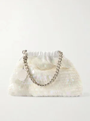 A white handbag covered in iridescent sequins, featuring a silver chain handle and a round metal charm, inspired by the chic style of the Stella McCartney Falabella Mini Metallic Cracked Vegan Shoulder Bag.