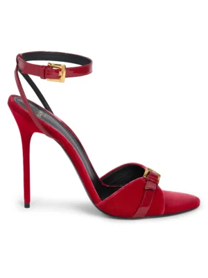 A red high-heeled sandal inspired by the Balmain 95MM Chain-Link & Leather T-Strap Sandals, featuring a pointed toe, ankle strap with gold buckle, thin stiletto heel, black insole, and a decorative buckle on the front strap.