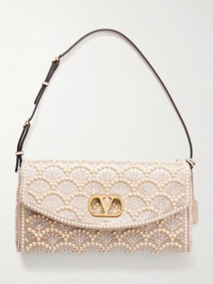 A rectangular, light beige handbag with a flap closure, decorated with pearl and bead embellishments in a scalloped pattern, a gold-tone logo clasp, and an adjustable shoulder strap—an elegant nod to the Valentino Garavani DeVain Sequined Shoulder Bag.